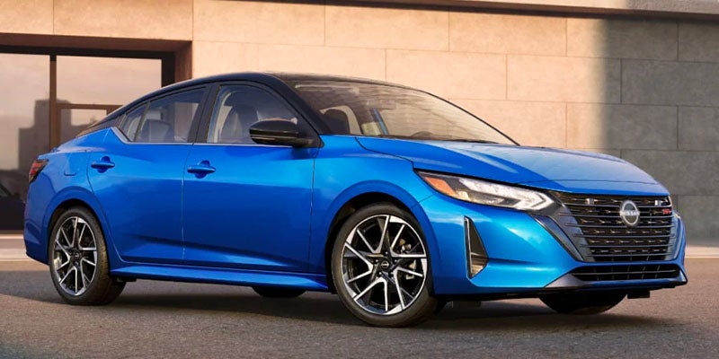 White Nissan sedan side view